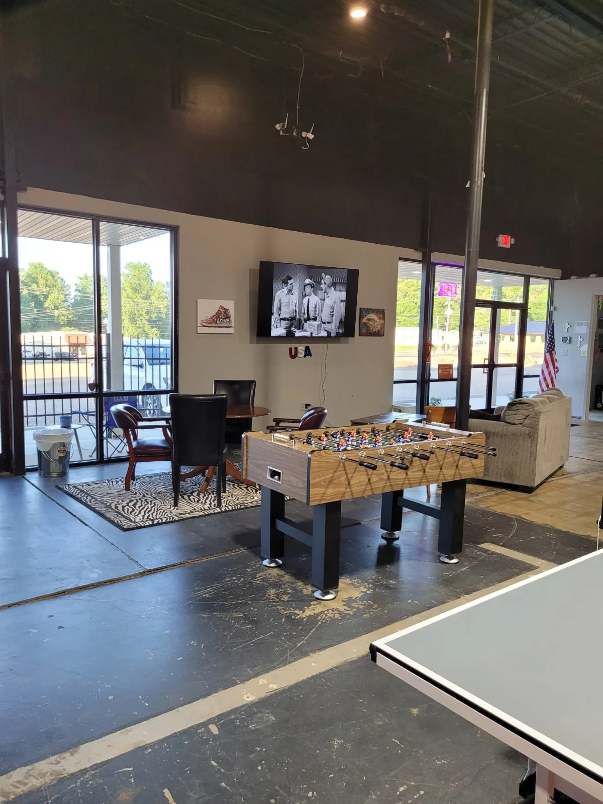 Foosball, table seating, and ping pong inside Game On