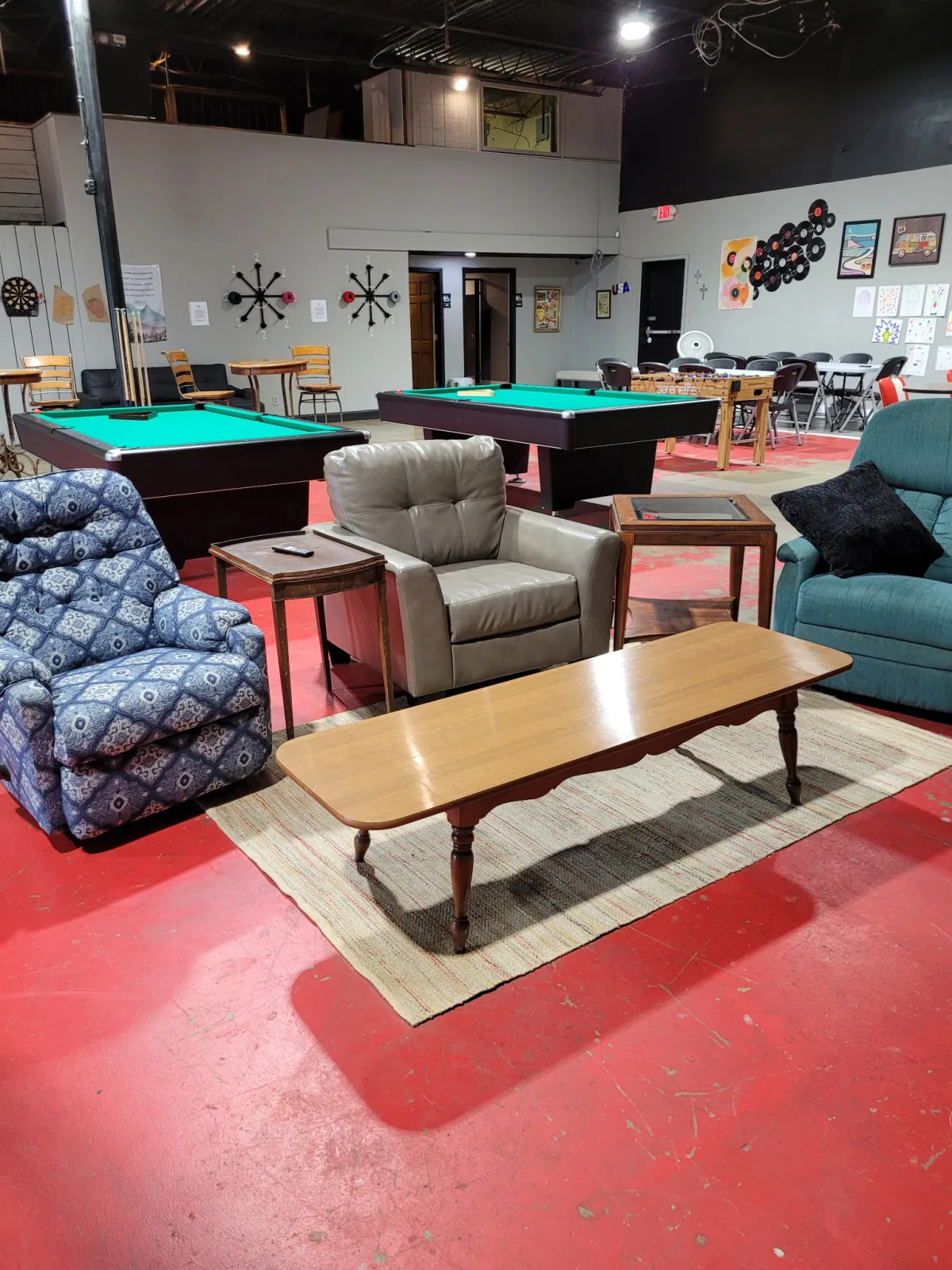 Lounge seating beside pool tables and foosball at Game On